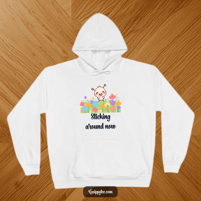 Funny needle character with a hearty laugh, playfully poking a colorful patch, printed on a warm hoodie.