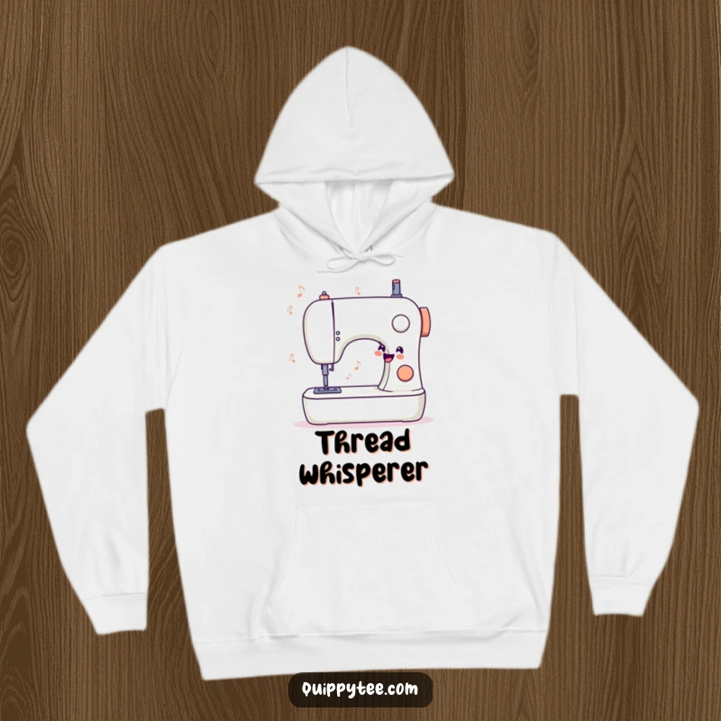 Funny hoodie showcasing a stylized sewing machine humming a sweet, happy tune, designed for ultimate comfort during creative projects.